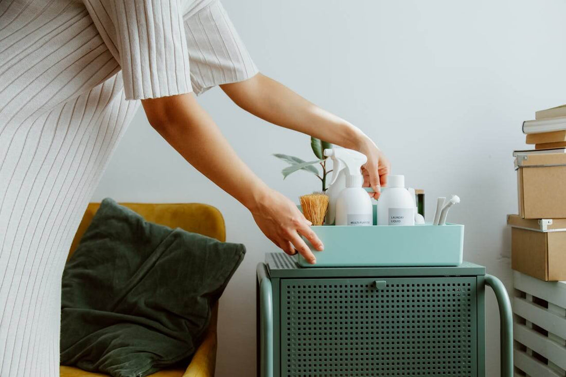 Middle-aged woman doing home cleaning using store-bought products.